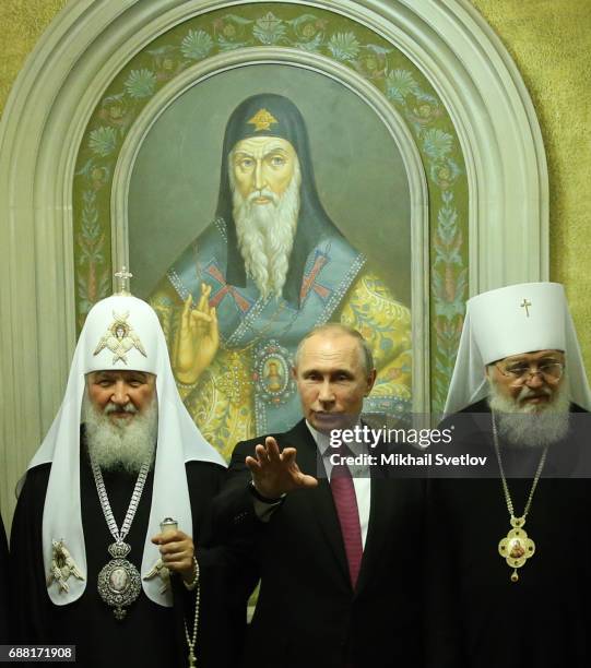 Russian President Vladimir Putin and Orthodox Patriarch Kirill pose for a photo while visiting the Sretensky Monastery, in Moscow, Russia, May 25,...