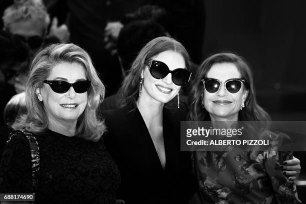 French actress Catherine Deneuve, US actress and member of the Feature Film jury Jessica Chastain and French actress Isabelle Huppert pose on May 23,...