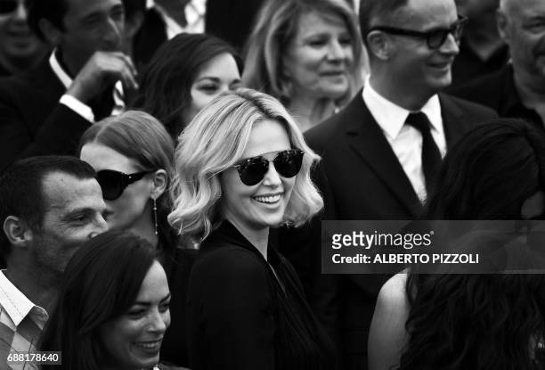 South African actress Charlize Theron poses on May 23, 2017 during a photocall for the '70th Anniversary' of the Cannes Film Festival in Cannes,...