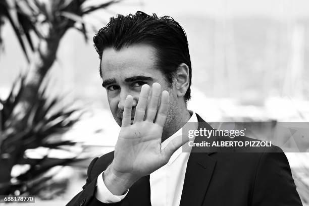 Irish actor Colin Farrell waves as she leaves on May 24, 2017 a photocall for the film 'The Beguiled' at the 70th edition of the Cannes Film Festival...