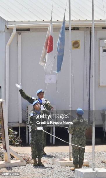 Japanese Ground Self-Defense Force personnel pull down the Japanese flag at their barracks in Juba, South Sudan, on May 25 as Japan ended its...