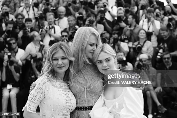 Actress Kirsten Dunst, Australian-US actress Nicole Kidman and US actress Elle Fanning pose on May 24, 2017 during a photocall for the film 'The...