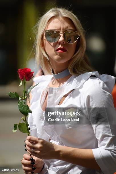 Members of the public queue to lay their floral tributes following a national minute's silence in remembrance of all those who lost their lives in...