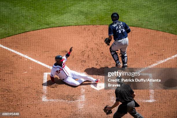 Adonis Garcia of the Atlanta Braves scores a run against the San Diego Padres at SunTrust Park on April 17, 2017 in Atlanta, Georgia. The Braves won...