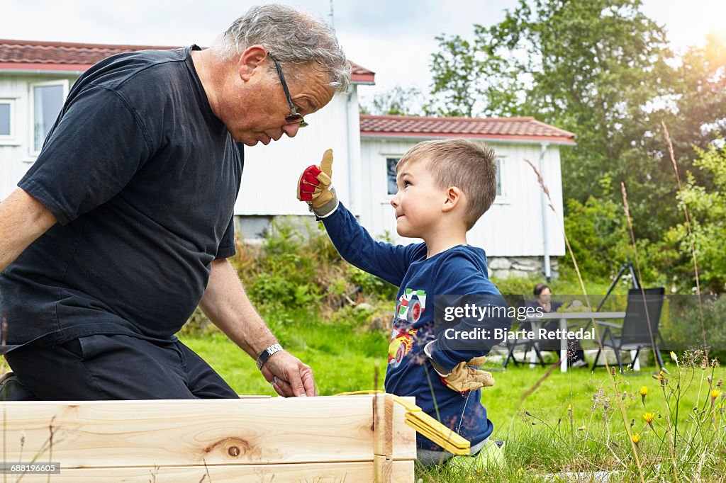 Boy helping Grandfather with joinery