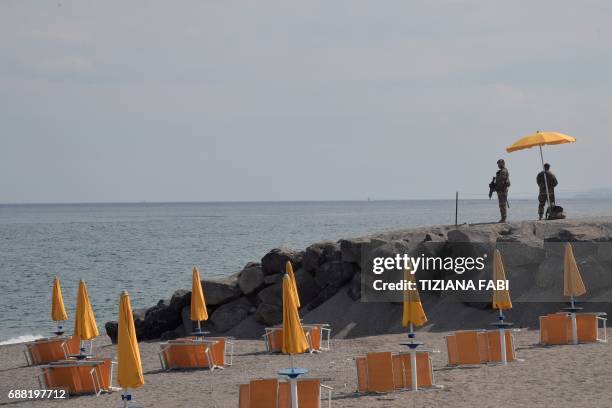 Italian soldiers control the access to the beach near the Media Center of the G7 in the coastal town of Giardini Naxos, south of Taormina, on May 25,...