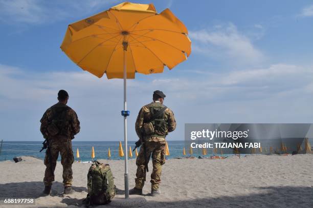 Italian soldiers control the access to the beach near the Media Center of the G7 in the coastal town of Giardini Naxos, south of Taormina, on May 25,...