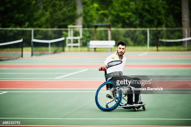 Adaptive athlete warming up for wheelchair tennis match