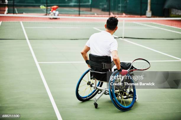 adaptive athletes playing wheelchair tennis match - wheelchair tennis stock pictures, royalty-free photos & images