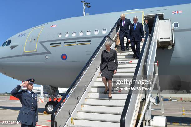 British Prime Minister Theresa May, Foreign Secretary Boris Johnson and Defence Secretary Sir Michael Fallon disembark a plane as they arrive to...