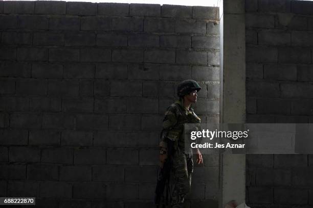 Soldier taking a look at enemy positions as they try to clear the city of armed militants one street at a time on May 25, 2017 in Marawi city,...