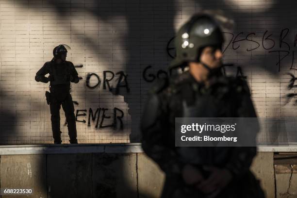 Federal army soldiers stand guard outside the vandalized Treasury Ministry building in Brasilia, Brazil, on Thursday, May 25, 2017. President Michel...