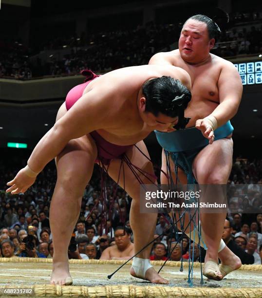 Mongolian sekiwake Tamawashi throws Endo to win during day ten of the Grand Sumo Summer Tournament at Ryogoku Kokugikan on May 23, 2017 in Tokyo,...