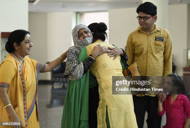 Uzma Ahmed hugs her mother as Union External Affairs Minister Sushma Swaraj, her brother and daughter look on at Jawahar Bhawan after returning from...