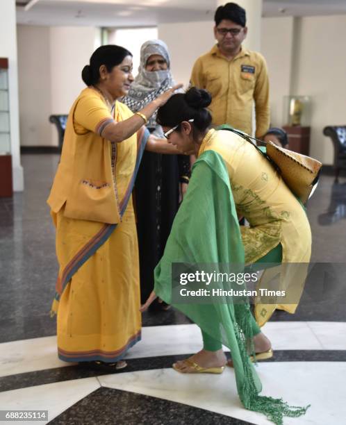 Uzma Ahmed touches feet of Union External Affairs Minister Sushma Swaraj at Jawahar Bhawan after returning from Pakistan on May 25, 2017 in New...