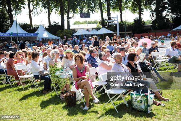 Visitors sit on chairs in the sunshine as a band performs at the Chelsea Flower Show on May 25, 2017 in London, England. Visitors enjoy warm weather...