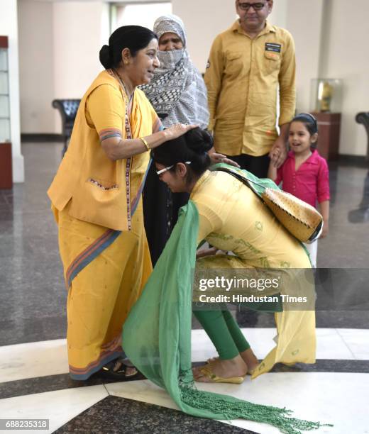 Uzma Ahmed touches feet of Union External Affairs Minister Sushma Swaraj at Jawahar Bhawan after returning from Pakistan on May 25, 2017 in New...