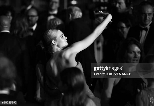 Actress Elle Fanning takes a selfie photo as she leaves on May 24, 2017 following the screening of the film 'The Beguiled' at the 70th edition of the...