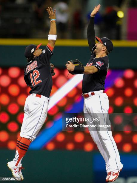 Shortstop Francisco Lindor and rightfielder Lonnie Chisenhall of the Cleveland Indians high five in celebration after winning Game 2 of the American...