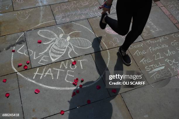 Nperson walks past a chalk message reading "Love not Hate" in St Ann's Square in Manchester, northwest England on May 25 placed in tribute to the...