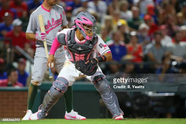 Adam Rosales of the Oakland Athletics looks on as Robinson Chirinos of the Texas Rangers throws to second base ""in the sixth inning at Globe Life...