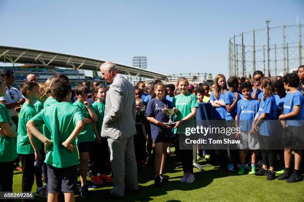 The Prince of Wales meets and greets kids at the launch of the ICC Champions Trophy at The Oval on May 25, 2017 in London, England.