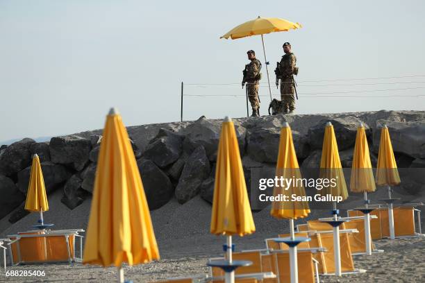 Armed Italian soldiers stand at the beach near the media center for the G7 Taormina summit on the island of Sicily on May 25, 2017 in Giardini Naxos,...