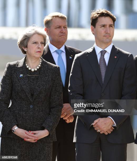 Britain's Prime Minister Theresa May, Romanian President Klaus Werner Iohannis and Canadian Prime Minister Justin Trudeau attend the unveiling...