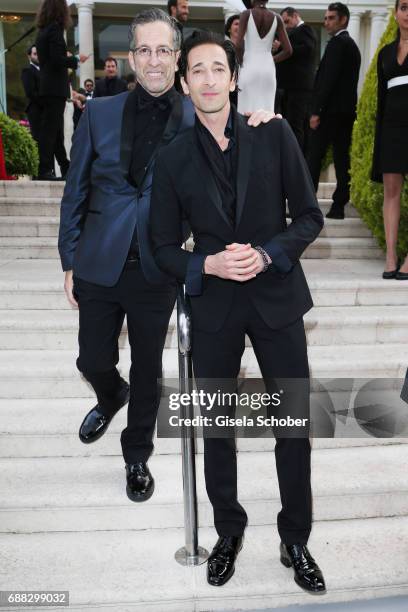 Kenneth Cole and Adrien Brody arrive at the amfAR Gala Cannes 2017 at Hotel du Cap-Eden-Roc on May 25, 2017 in Cap d'Antibes, France.