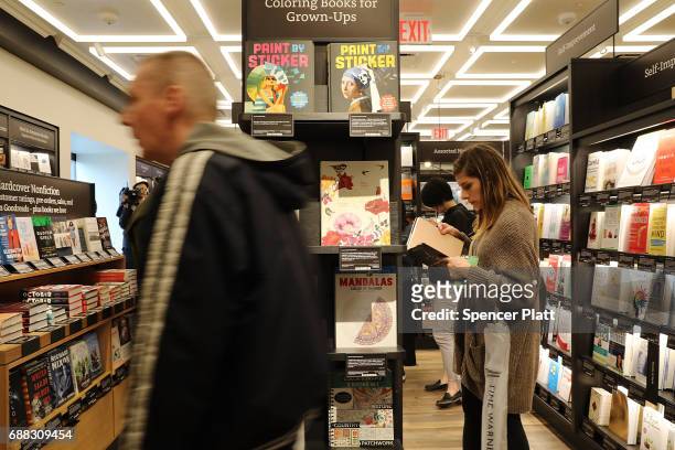 People shop in the newly opened Amazon Books on May 25, 2017 in New York City. Amazon.com Inc.'s first New York City bookstore occupies 4,000 square...