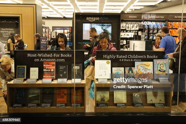 People shop in the newly opened Amazon Books on May 25, 2017 in New York City. Amazon.com Inc.'s first New York City bookstore occupies 4,000 square...