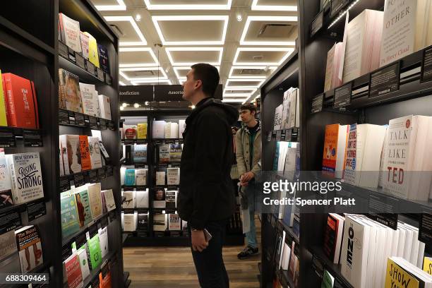 People shop in the newly opened Amazon Books on May 25, 2017 in New York City. Amazon.com Inc.'s first New York City bookstore occupies 4,000 square...