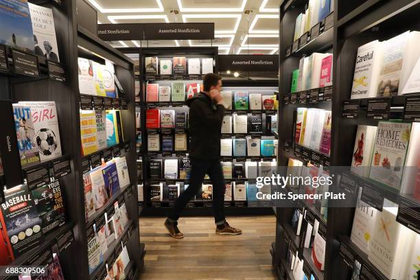 People shop in the newly opened Amazon Books on May 25, 2017 in New York City. Amazon.com Inc.'s first New York City bookstore occupies 4,000 square...