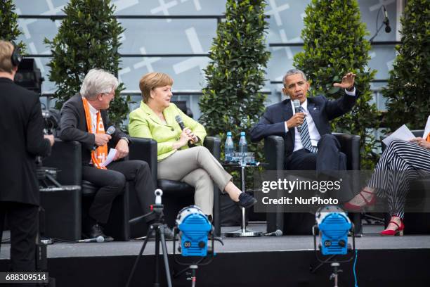 Former US President Barack Obama and German Chancellor Angela Merkel attend a panel discussion about democracy at the Protestant Kirchentag in...