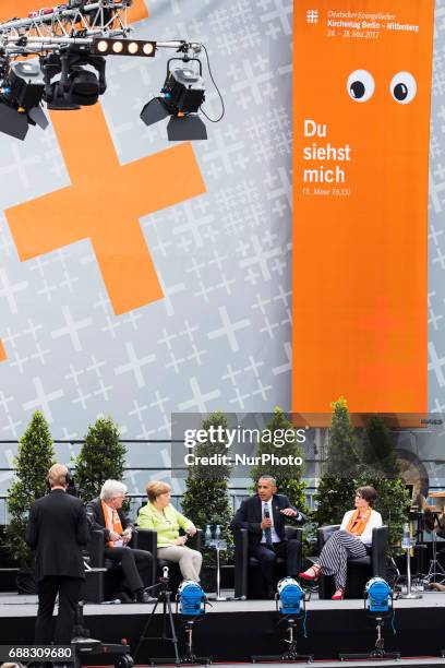 Former US President Barack Obama and German Chancellor Angela Merkel attend a panel discussion about democracy at the Protestant Kirchentag in...