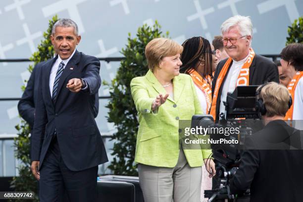 Former US President Barack Obama and German Chancellor Angela Merkel leave after attending a panel discussion about democracy at the Protestant...