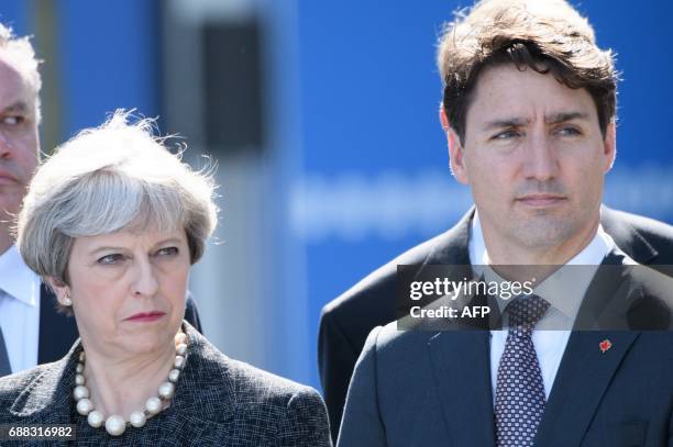Canadian Prime Minister Justin Trudeau and Britain's Prime Minister Theresa May attend the unveiling ceremony of the new NATO headquarters in...
