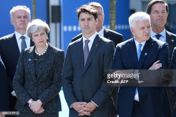 Britain's Prime Minister Theresa May, Canadian Prime Minister Justin Trudeau and Montenegro's Prime Minister Dusko Markovic attend the unveiling...
