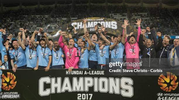 Sydney FC celebrate by holding up the A-League Trophy beating Victory in a penalty shootout during the 2017 A-League Grand Final match between Sydney...