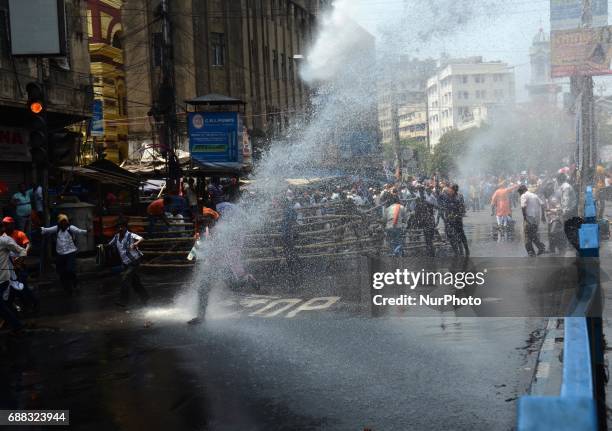 Indian police fire water cannons to disperse the Bharatiya Janata Party activists during their march to the police headquarters in Kolkata, India on...