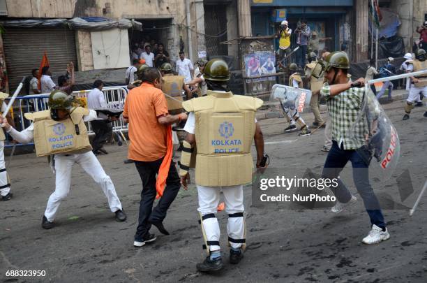Indian police disperse the Bharatiya Janata Party activists during their march to the police headquarters in Kolkata, India on Thursday, 25th...
