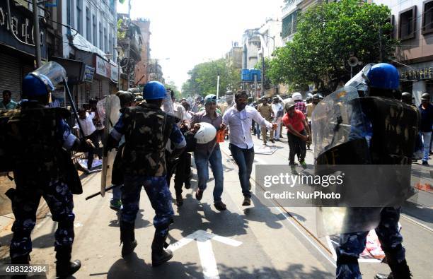 Indian police disperse the Bharatiya Janata Party activists during their march to the police headquarters in Kolkata, India on Thursday, 25th...