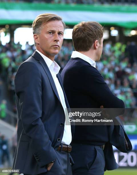 Head coach Andries Jonker of Wolfsburg stands next to sporting director Olaf Rebbe of Wolfsburg prior to the Bundesliga Playoff first leg match...