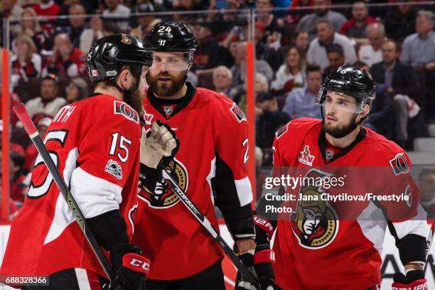 Zack Smith, Viktor Stalberg and Chris Wideman of the Ottawa Senators chat during a break in a game against the Pittsburgh Penguins in Game Six of the...