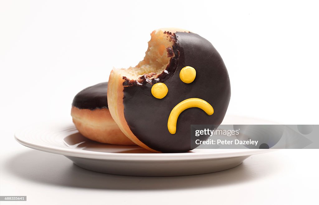 Unhealthy doughnut on plate