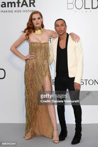 Alexina Graham and Olivier Rousteing arrive at the amfAR Gala Cannes 2017 at Hotel du Cap-Eden-Roc on May 25, 2017 in Cap d'Antibes, France.