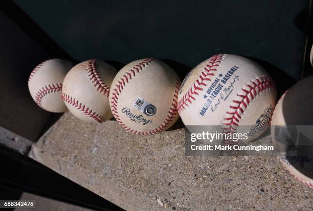 Detailed view of a group of authenticated official Rawlings MLB baseballs sitting in the dugout during the Opening Day game between the Boston Red...