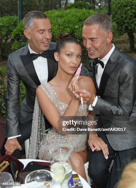 Dan Caten, Bella Hadid and Dean Caten attend the amfAR Gala Cannes 2017 at Hotel du Cap-Eden-Roc on May 25, 2017 in Cap d'Antibes, France.