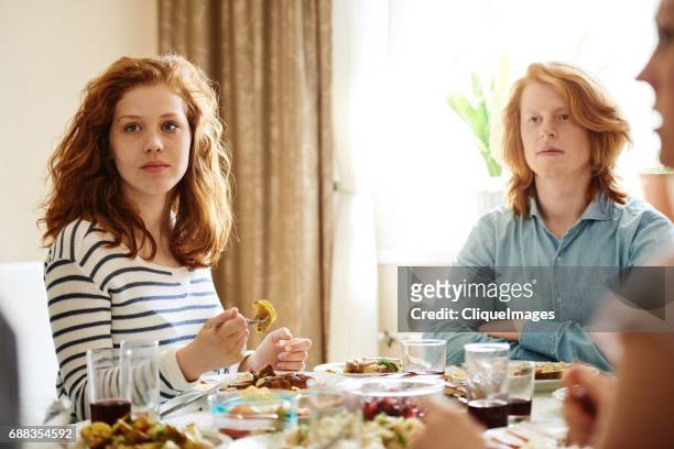 ginger brother and sister on family dinner - family at dining table stock pictures, royalty-free photos & images