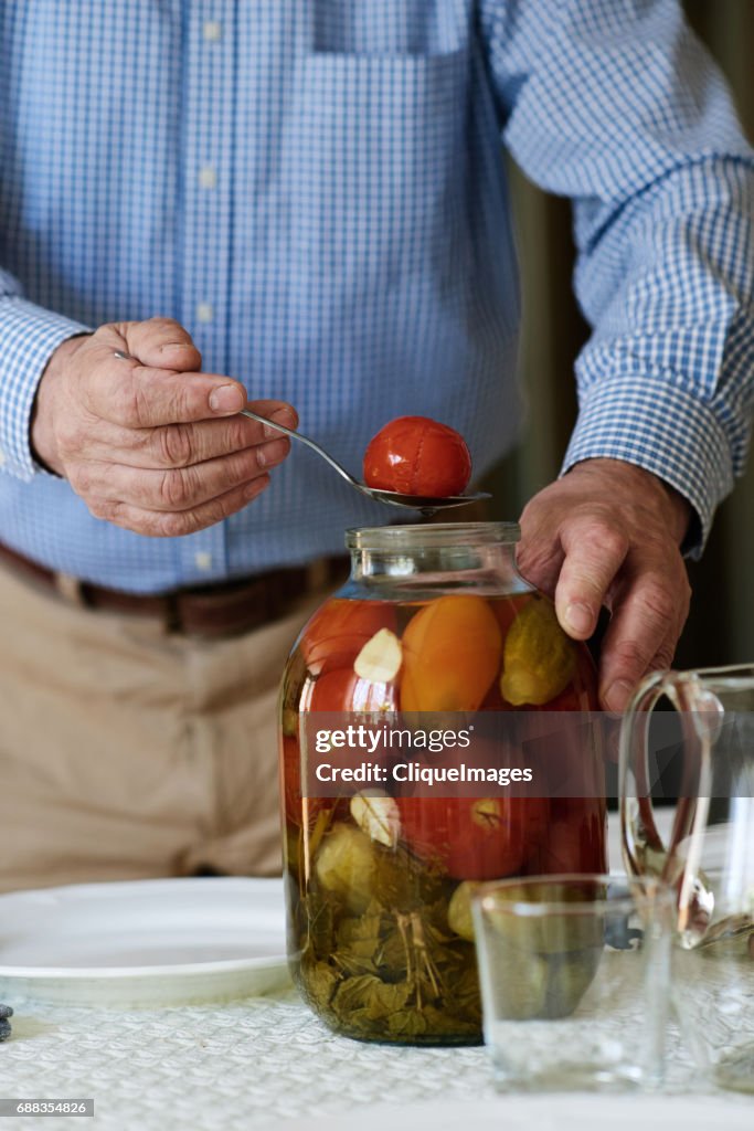 Man taking pickles out for taste